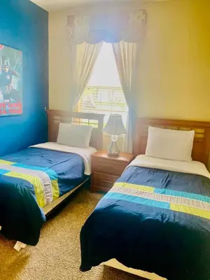 a bedroom with two beds and a window at Paraíso Magico Getaway 5152 in Kissimmee