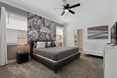 a bedroom with a bed and a ceiling fan at 2900SS SL Family Lakeview Escape Disney-Themed Fun 8 Mins to Parks in Kissimmee