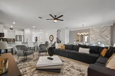 a living room with a couch and a dining room at 2900SS SL Family Lakeview Escape Disney-Themed Fun 8 Mins to Parks in Kissimmee