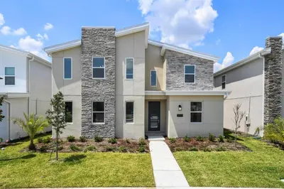 a large white house with a grass yard at 2900SS SL Family Lakeview Escape Disney-Themed Fun 8 Mins to Parks in Kissimmee
