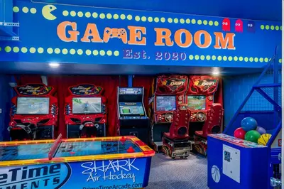 a gaming room with arcade machines and a game room with a sign at Free Waterpark|Game Room|Near Dis! in Orlando