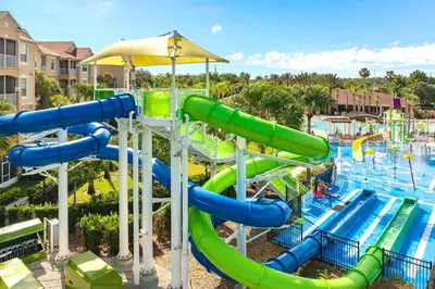 a water slide at a resort with a pool at Free Waterpark|Game Room|Near Dis! in Orlando