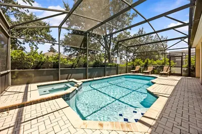 an indoor swimming pool with a clear glass roof at Free Waterpark|Game Room|Near Dis! in Orlando