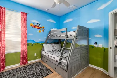 a childs room with a bunk bed and blue walls at Free Waterpark|Game Room|Near Dis! in Orlando