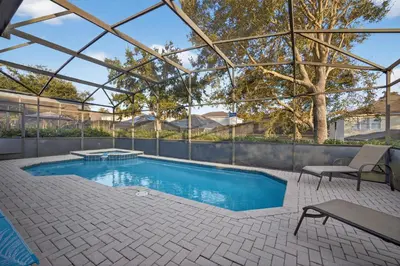 an indoor swimming pool with a glass roof at Free Waterpark|Game Room|Near Dis! in Orlando