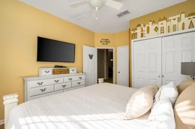 a bedroom with a bed and a flat screen tv at Free Waterpark|Game Room|Near Dis! in Orlando