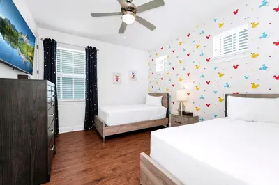 a bedroom with two beds and a ceiling fan at Spacious Home With Private Pool And Game Room Near Disney With Waterpark Access At Encore Resorts Reunion - 390La in Orlando