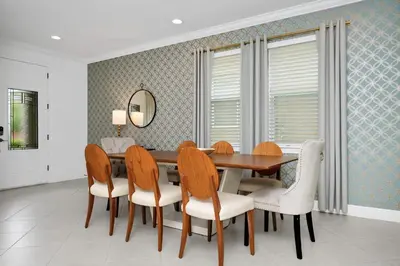 a dining room with a table and chairs at Spacious Home With Private Pool And Game Room Near Disney With Waterpark Access At Encore Resorts Reunion - 390La in Orlando