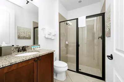 a bathroom with a toilet sink and a shower at Spacious Home With Private Pool And Game Room Near Disney With Waterpark Access At Encore Resorts Reunion - 390La in Orlando