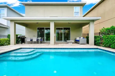 a swimming pool in front of a house at Spacious Home With Private Pool And Game Room Near Disney With Waterpark Access At Encore Resorts Reunion - 390La in Orlando