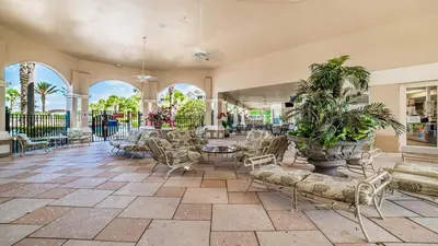 a lobby with chairs and tables and windows at 2784 Almaton 404 in Orlando