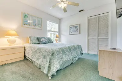 a bedroom with a bed and a ceiling fan at 12 Mi to Disney Secluded Family Home with Pool in Kissimmee