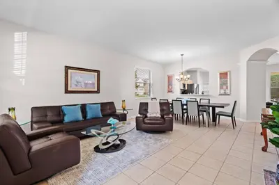 a living room with a couch and a dining room at Large house at Windsor Hills Resort in Orlando