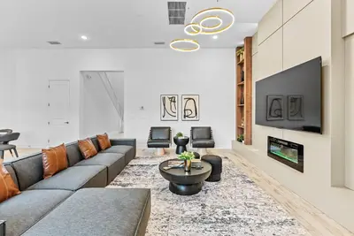 a living room with a couch and a tv at Brand NEW 11 Bedrooms At Sonoma in Kissimmee