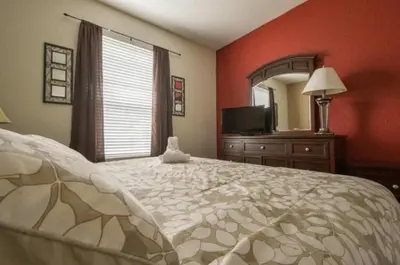 a bedroom with a large bed and a mirror at 2 Bedroom private lakeview by Conference Center and Epic Universe walking distance in Orlando