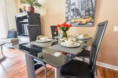 a dining room table with chairs and a dining room at 2 Bedroom private lakeview by Conference Center and Epic Universe walking distance in Orlando