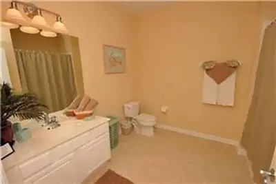 a bathroom with a sink and a toilet at 2 Bedroom private lakeview by Conference Center and Epic Universe walking distance in Orlando