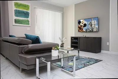 a living room with a couch and a coffee table at 5BR Private Pool Resort Amenities Near Disney in Kissimmee