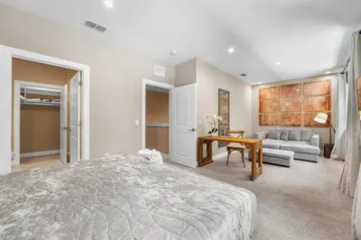a bedroom with a bed and a living room at Magic Getaway 4 En-suites, BBQ & Near Parks in Orlando