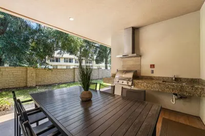 a kitchen with a wooden table with a plant on it at Magic Getaway 4 En-suites, BBQ & Near Parks in Orlando