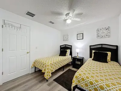 a bedroom with two beds and a ceiling fan at Terra Verde Resort 4 Bed Pool Spa Villa villa in Kissimmee