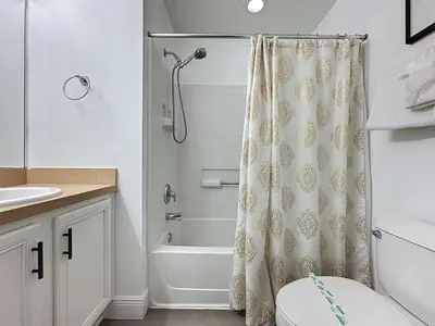 a bathroom with a shower curtain and a toilet at Terra Verde Resort 4 Bed Pool Spa Villa villa in Kissimmee