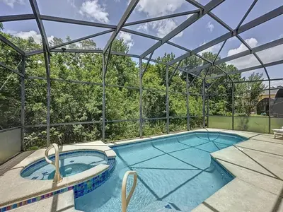 an indoor swimming pool with a glass roof at Terra Verde Resort 4 Bed Pool Spa Villa villa in Kissimmee