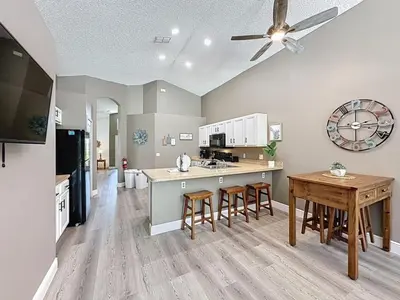 a large kitchen with a table and a dining room at Terra Verde Resort 4 Bed Pool Spa Villa villa in Kissimmee