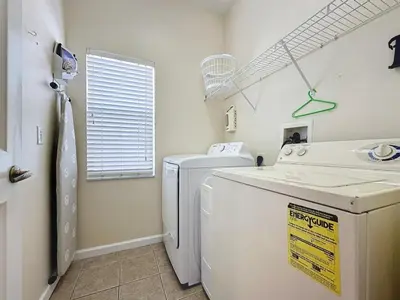 a laundry room with a washing machine and a window at Walk to Silver Spurs Rodeo and Heritage Park home in Kissimmee