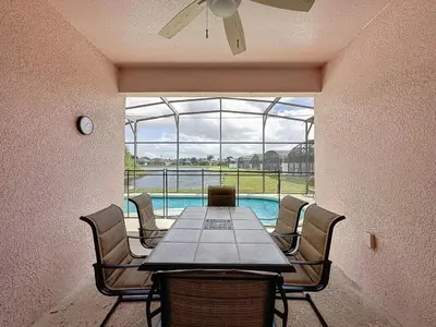 a dining room with a table and chairs and a pool at Walk to Silver Spurs Rodeo and Heritage Park home in Kissimmee