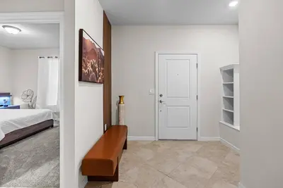a bedroom with a bed and a white wall at Brand New 05 Bedrooms At Windsor Cay in Orlando
