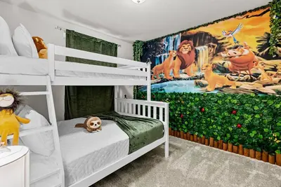 a bedroom with bunk beds and a mural of the lion king at Brand New 05 Bedrooms At Windsor Cay in Orlando