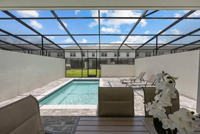 a swimming pool with a glass roof over it at Brand New 05 Bedrooms At Windsor Cay in Orlando