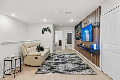a living room with a couch and a tv at Brand New 05 Bedrooms At Windsor Cay in Orlando