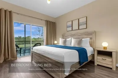 a bedroom with a bed and a balcony at Charming 3-Bedroom Home in Gated Oakwater Resort in Orlando