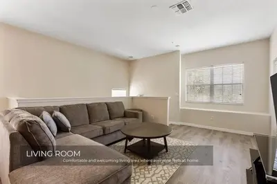 a living room with a couch and a table at Charming 3-Bedroom Home in Gated Oakwater Resort in Orlando