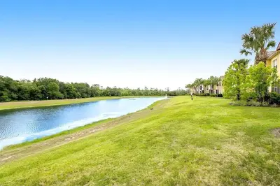 a view of a river with grass and houses at Charming 3-Bedroom Home in Gated Oakwater Resort in Orlando