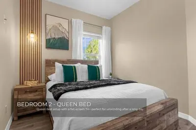 a bedroom with a bed with green and white pillows at Charming 3-Bedroom Home in Gated Oakwater Resort in Orlando