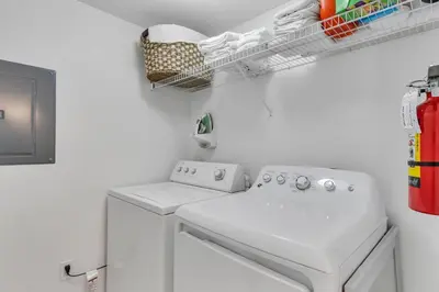 a laundry room with a washing machine and a drying rack at Cozy Kissimmee Hideaway in Kissimmee