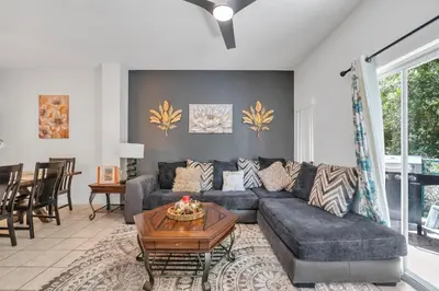 a living room with a couch and a table at Cozy Kissimmee Hideaway in Kissimmee