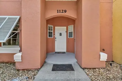 an entrance to a building with a white door at Cozy Kissimmee Hideaway in Kissimmee