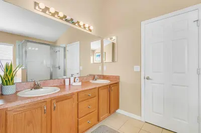 a bathroom with two sinks and a large mirror at Private Pool Villa, 3mi to Disney with Game Room in Kissimmee