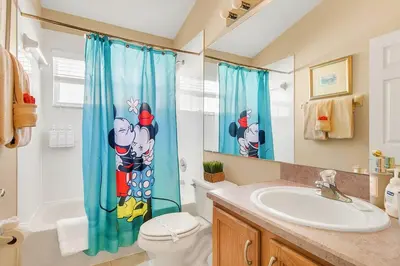 a bathroom with a toilet and a sink at Private Pool Villa, 3mi to Disney with Game Room in Kissimmee