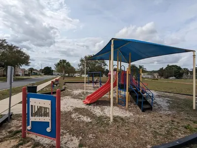 a playground with a red slide and a blue canopy at Private Pool Villa, 3mi to Disney with Game Room in Kissimmee
