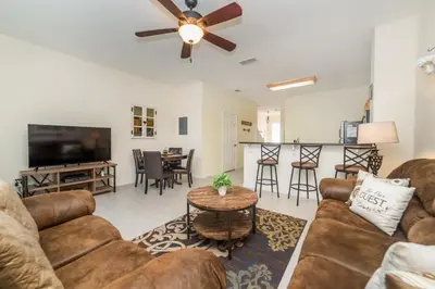 a living room with a couch and a flat screen tv at MSW2505 - Windsor Hills Resort Vacation Townhome in Orlando