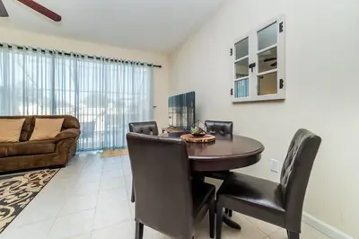 a dining room with a table and chairs and a couch at MSW2505 - Windsor Hills Resort Vacation Townhome in Orlando