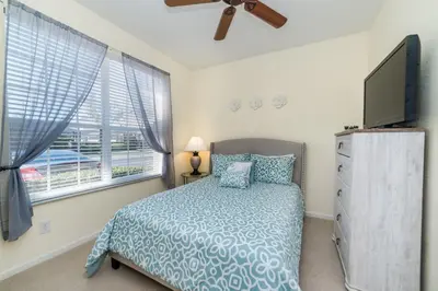 a bedroom with a bed and a flat screen tv at MSW2505 - Windsor Hills Resort Vacation Townhome in Orlando