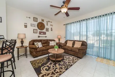 a living room with two couches and a ceiling fan at MSW2505 Windsor Hills 3 Bedroom Private Pool Townhome in Orlando