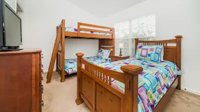 a bedroom with two bunk beds and a tv at OP7652 Windsor Hills 3 Bedroom Private Pool Townhome in Orlando