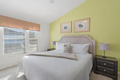 a bedroom with a white bed and a window at OP7678 Windsor Hills 3 Bedroom Private Pool Townhome in Orlando